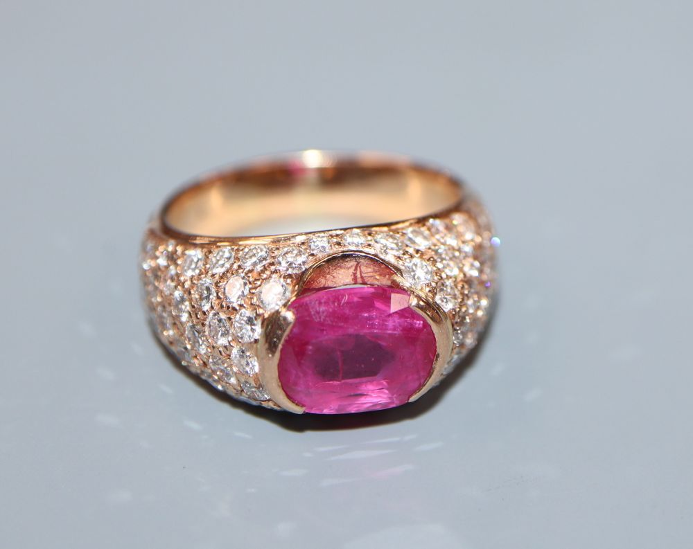 A yellow metal, ruby and diamond encrusted dress ring, size O, gross 11.3 grams.
